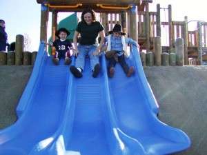 mom and boys on slide